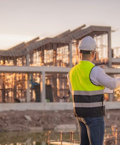 Two,Asian,Engineer,Working,At,Site,Of,A,Large,Building
